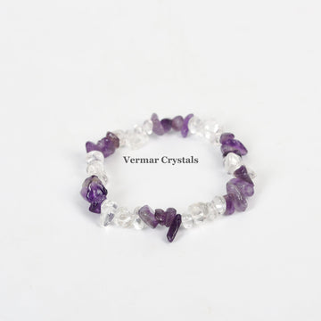 Stretchy bracelet made of irregular polished amethyst and clear quartz chip stones arranged in a circle on white background