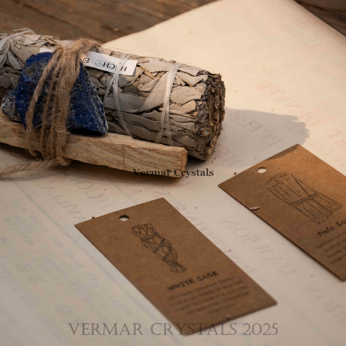 Bundle of white sage, Palo Santo stick, and blue Lapis Lazuli stone tied with natural twine for healing rituals.