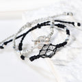 Handcrafted Herkimer Diamond crystal bracelets with durable braided cord and silver bead accents on white background