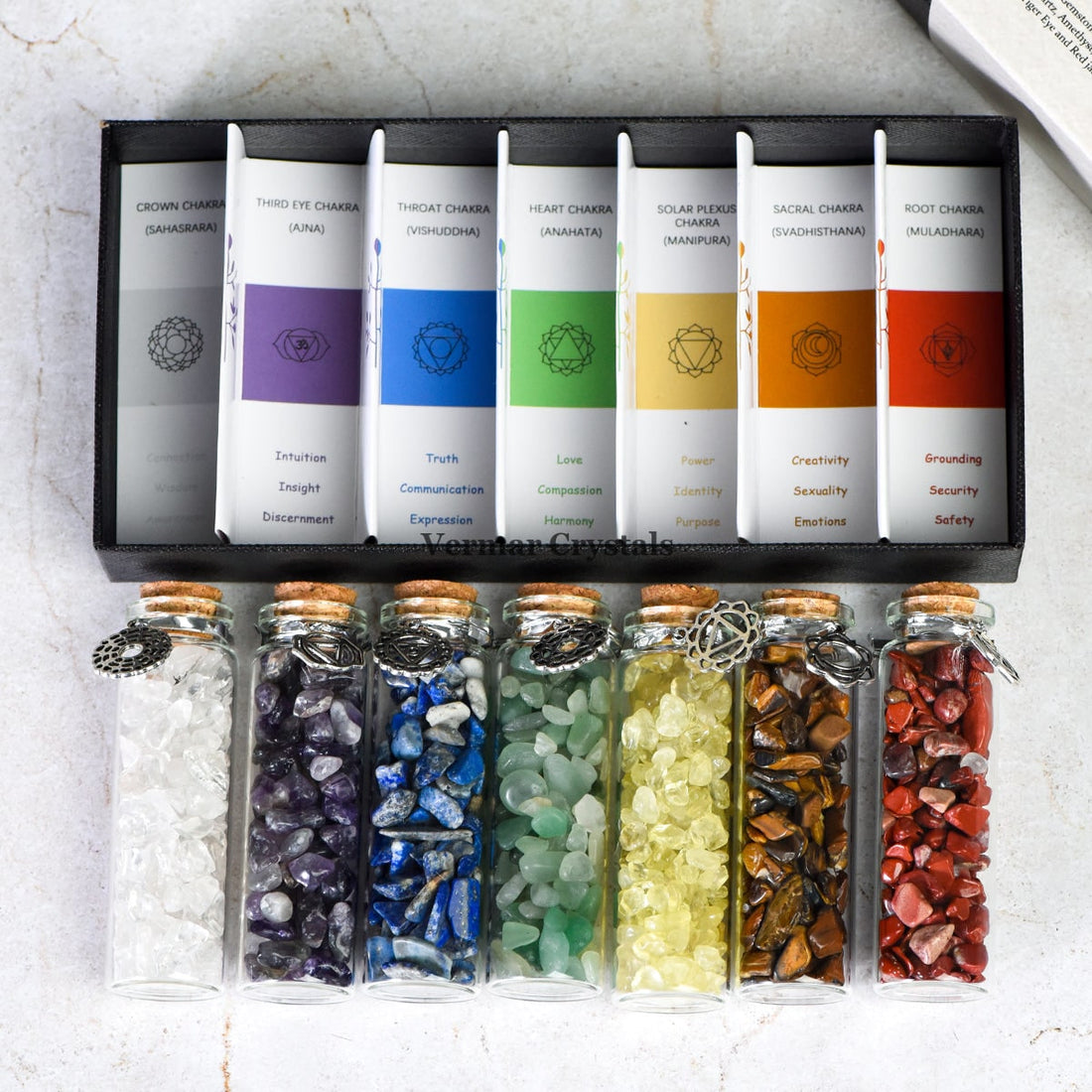 Chakra Healing Chip Stone Wishing Bottle Set with seven colorful stones in glass vials and chakra descriptions in a black box