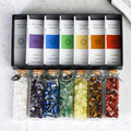 Chakra Healing Chip Stone Wishing Bottle Set with seven colorful stones in glass vials and chakra descriptions in a black box