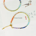 Seven faceted natural gemstone beads representing chakras with gold accents on an adjustable bracelet chain