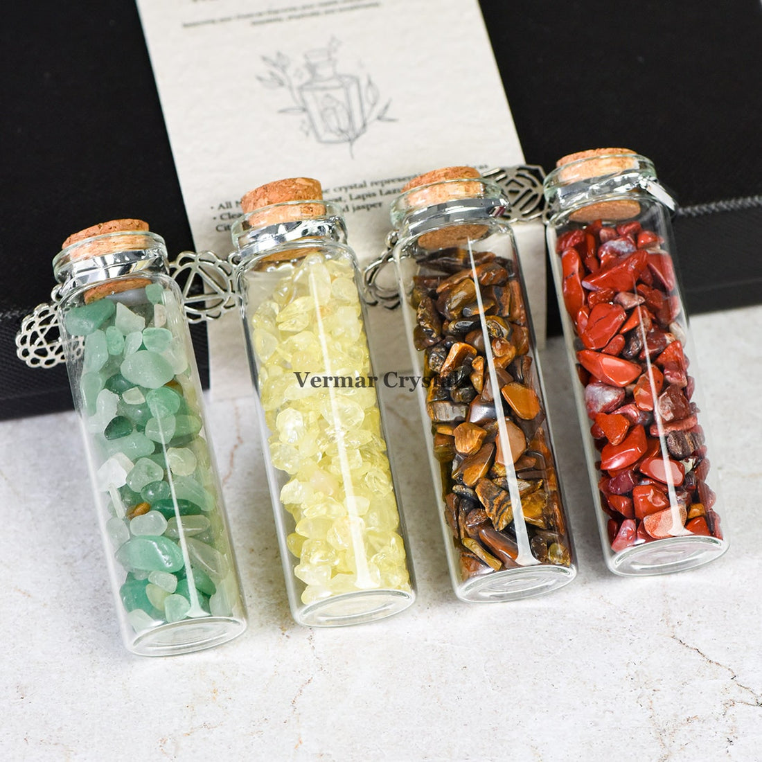 Chakra Healing Chip Stone Wishing Bottle Set with seven colorful stones in glass vials and chakra descriptions in a black box