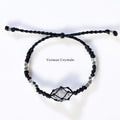 Handcrafted Herkimer Diamond crystal bracelet with braided black cord and silver beads on white background