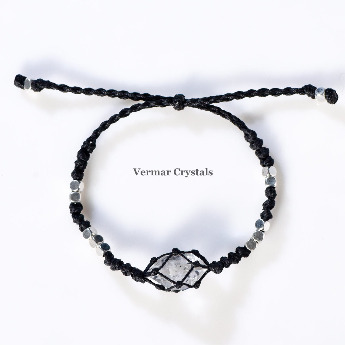 Handcrafted Herkimer Diamond crystal bracelet with braided black cord and silver beads on white background