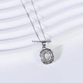 Delicate silver pendant with oval blue moonstone center and textured halo on fine silver chain against white background