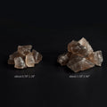 Natural smoky quartz crystal stones in two size groups on a black background with size measurements shown