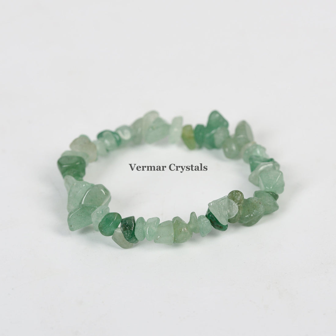 Handmade stretchy bracelet made of irregular polished green aventurine stone chips on a white background