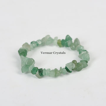 Handmade stretchy bracelet made of irregular polished green aventurine stone chips on a white background