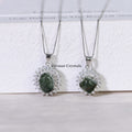 Two elegant silver necklaces with green phantom quartz stones surrounded by sparkling crystals on white surface