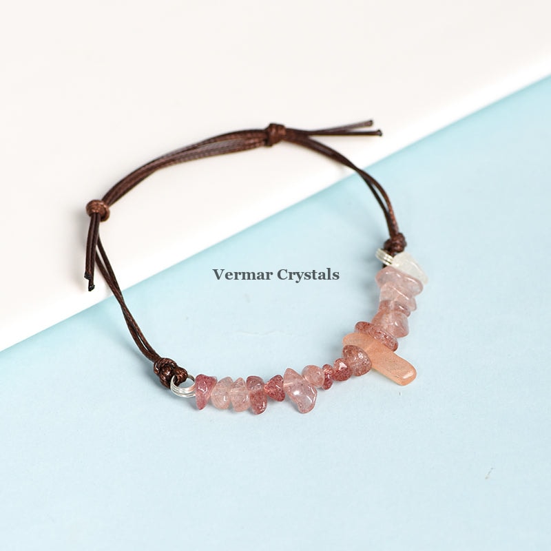 Handmade bracelet with natural strawberry quartz chip beads and a brown leather adjustable cord on a blue and white background