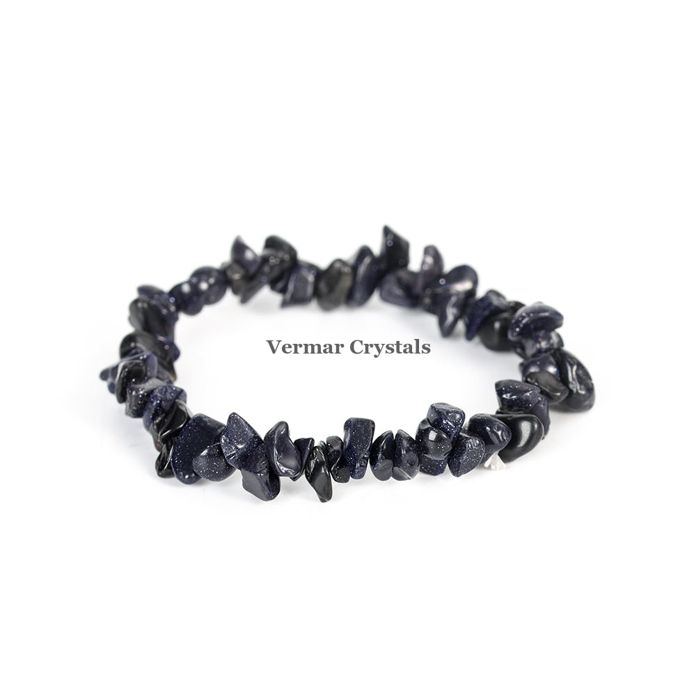 Stretchy bracelet made of irregular polished blue goldstone chip beads arranged in a circle on a white background