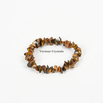 Handmade stretchy bracelet made of irregular polished brown and golden Tiger's Eye stone chips on white background