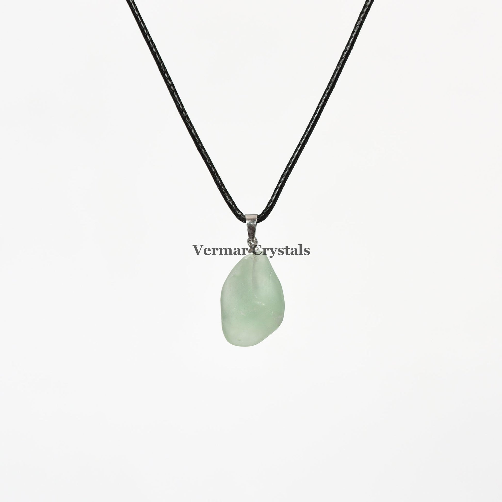 Natural raw green fluorite pendant necklace with soft translucent green stone on black cord background white