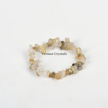 Handmade stretchy bracelet made of polished rutilated quartz chip beads arranged in a circular shape on white background
