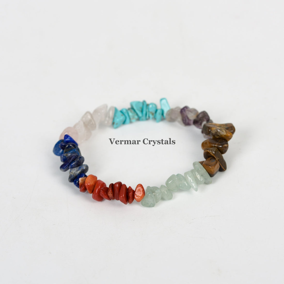 Handmade stretchy bracelet with polished irregular mixed gemstone chips in various colors on a white background