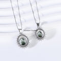 Two elegant silver necklaces with green phantom quartz center stones and halo settings on white background