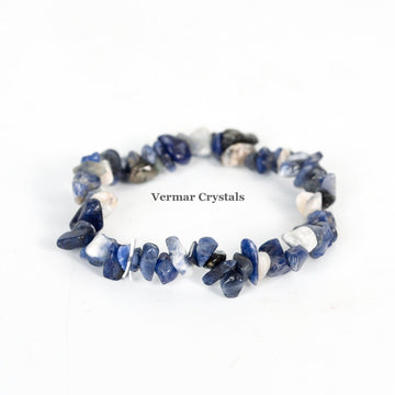 Handmade stretchy bracelet made of irregular polished blue and white sodalite chip beads on a white background