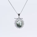 Elegant silver pendant necklace with green phantom quartz center stone surrounded by sparkling halo crystals