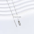 Delicate silver chain necklace with lobster clasp and small oval tag on white textured background