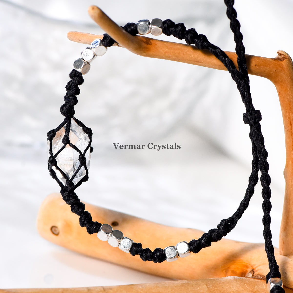 Handcrafted Herkimer Diamond crystal braided bracelet with silver beads on durable black cord against white background