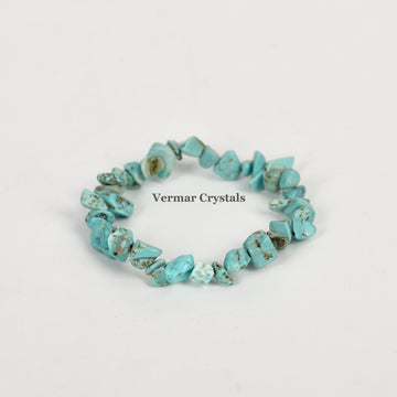 Handmade stretchy bracelet made of irregular turquoise chip stones arranged in a circle on a white background