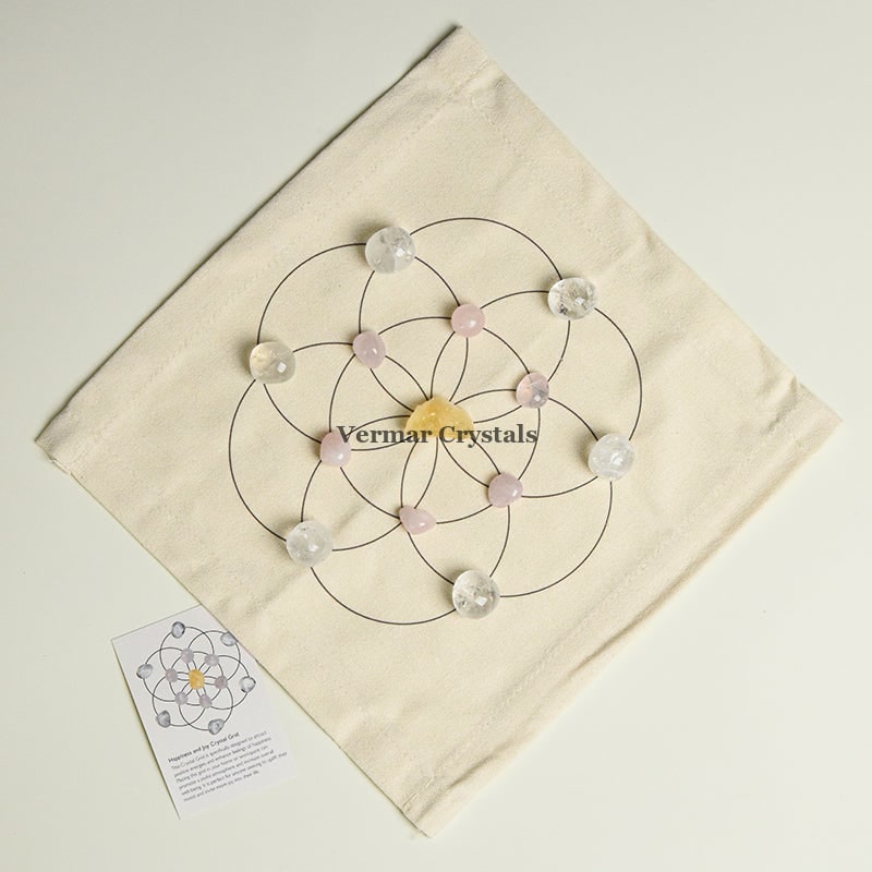 Happiness and Joy crystal grid set with clear quartz and rose quartz stones arranged on fabric cloth for positive energy
