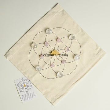 Happiness and Joy crystal grid set with clear quartz and rose quartz stones arranged on fabric cloth for positive energy
