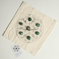 Abundance and good luck crystal grid set with green stones and clear quartz on fabric cloth for prosperity and success.