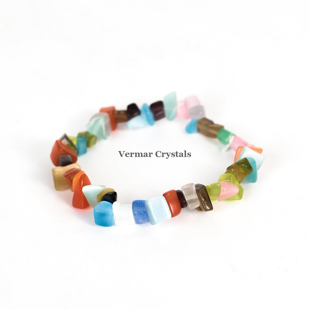 Handmade stretchy bracelet made of polished colorful chip stones arranged in a circular shape on white background