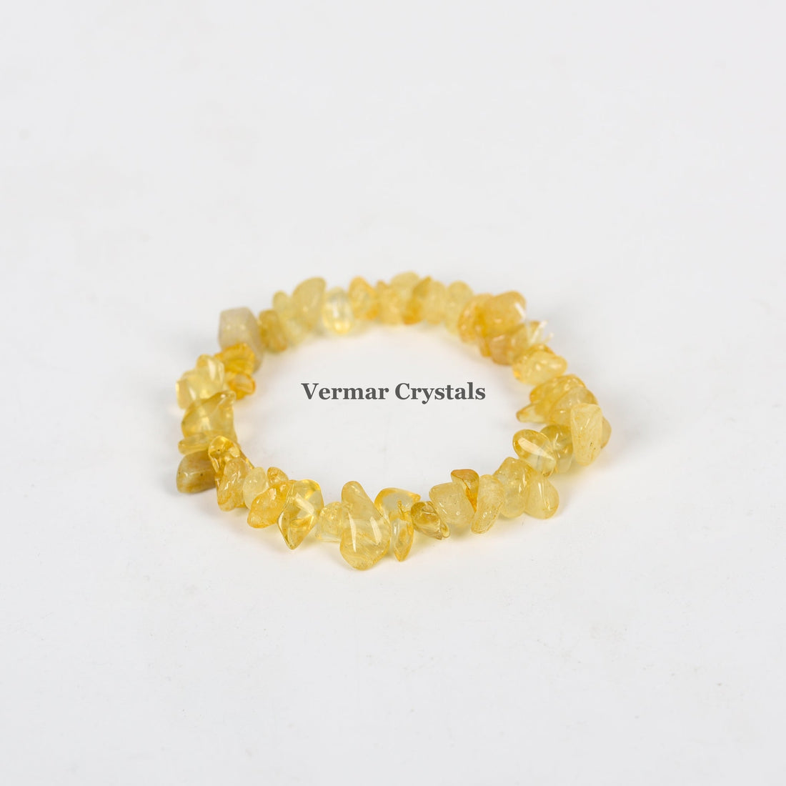 Handmade stretchy bracelet made of irregular yellow citrine crystal chip beads on a white background