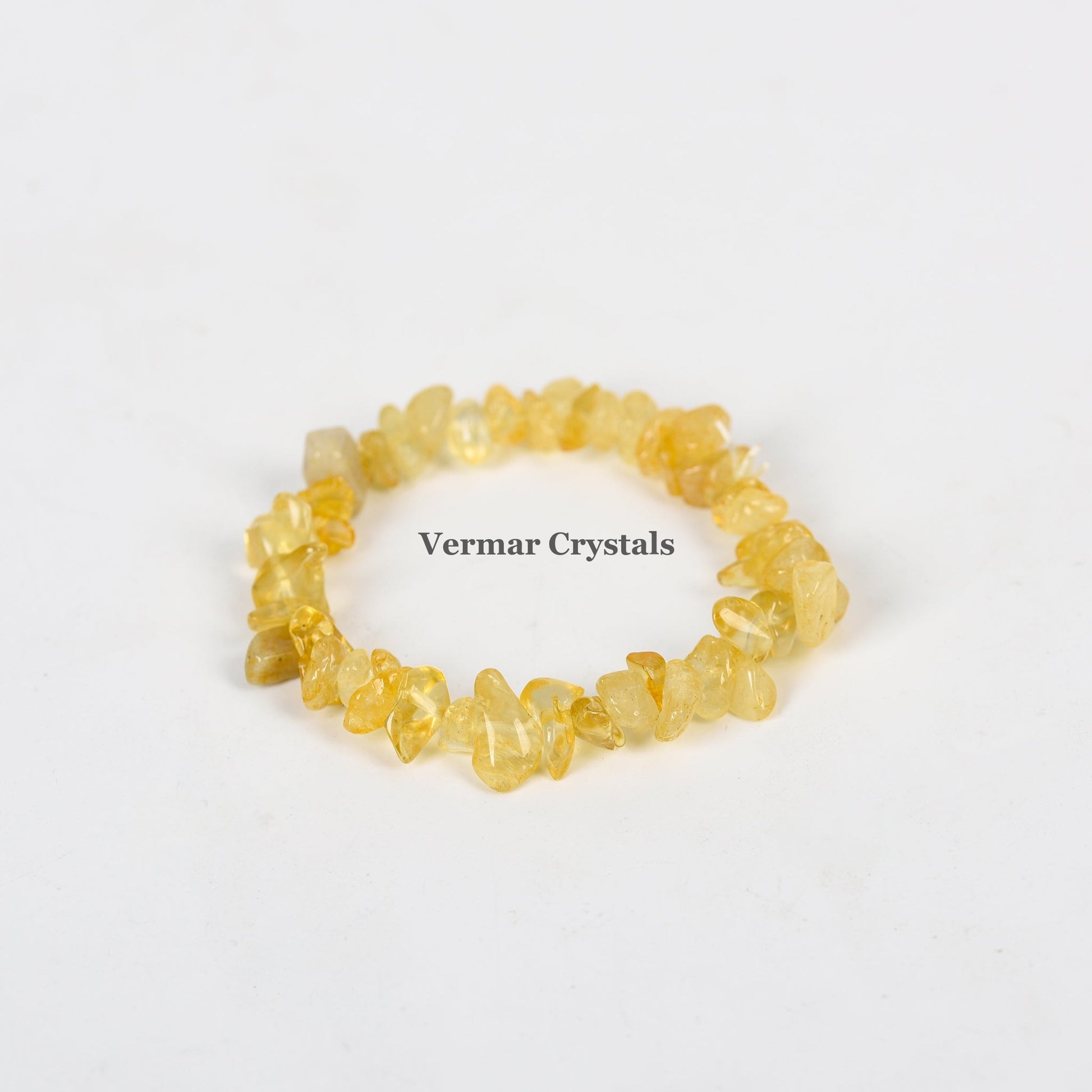 Handmade stretchy bracelet made of irregular yellow citrine crystal chip beads on a white background
