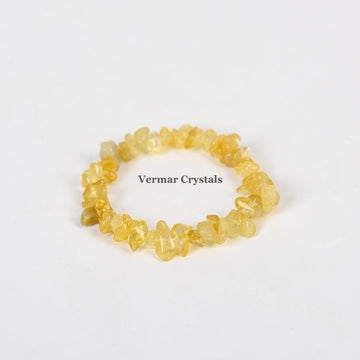 Handmade stretchy bracelet made of irregular yellow citrine crystal chip beads on a white background