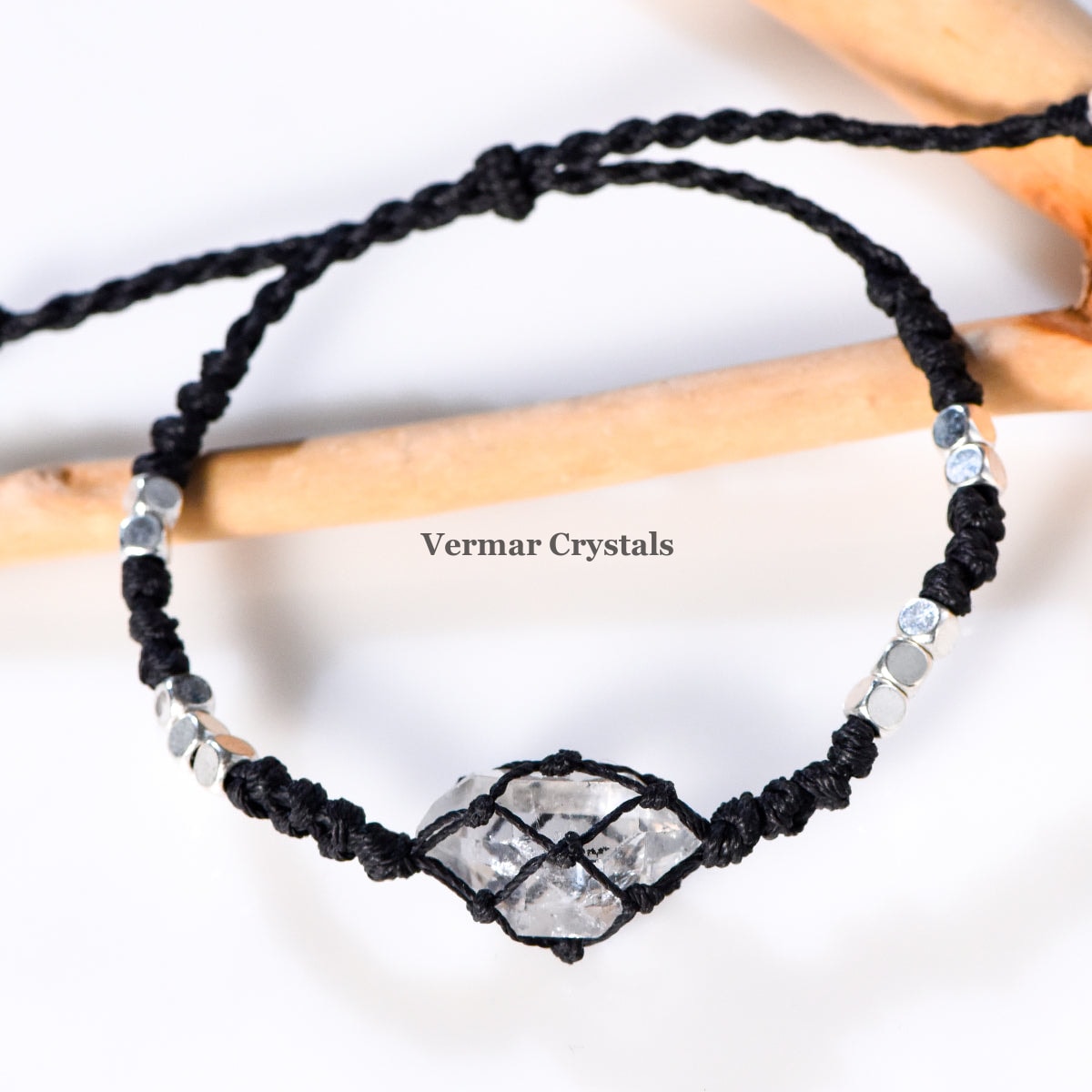 Handcrafted Herkimer Diamond crystal wrapped in black braided cord bracelet with silver bead accents on a white background