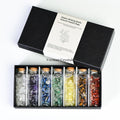 Chakra healing wishing bottle set with seven natural crystal chips in glass vials arranged in a black gift box