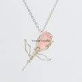 Handcrafted rose quartz rose pendant wrapped in silver wire on a delicate silver chain necklace against a white background