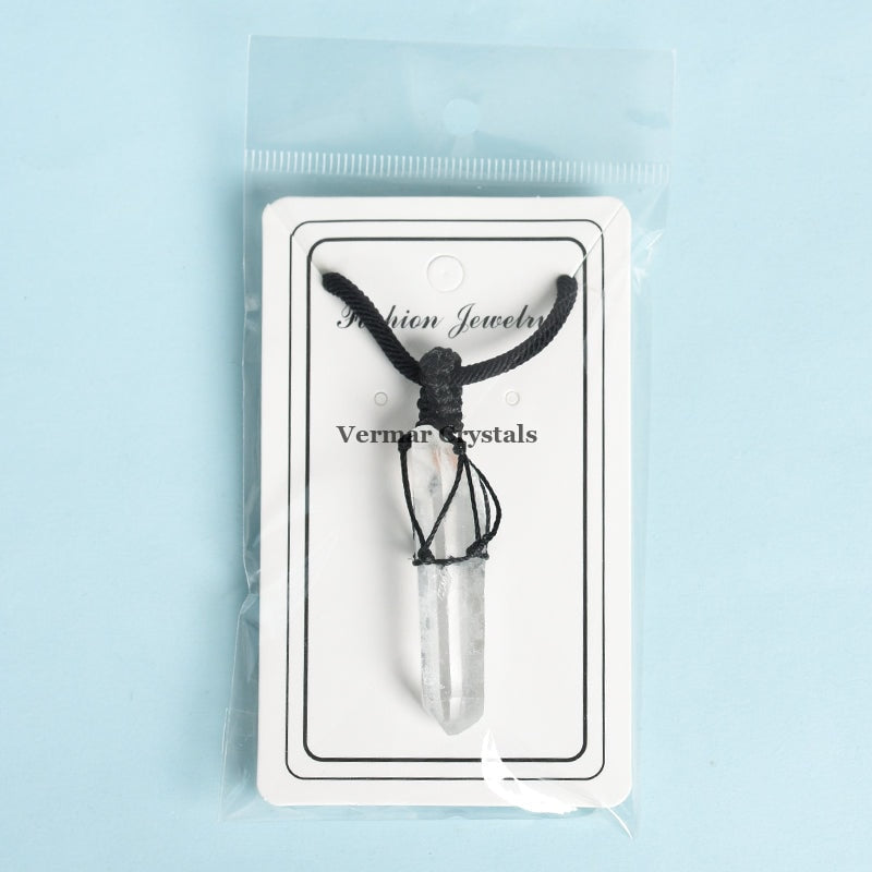 Clear quartz crystal point pendant wrapped in black cord with handwoven knots on display card in plastic bag