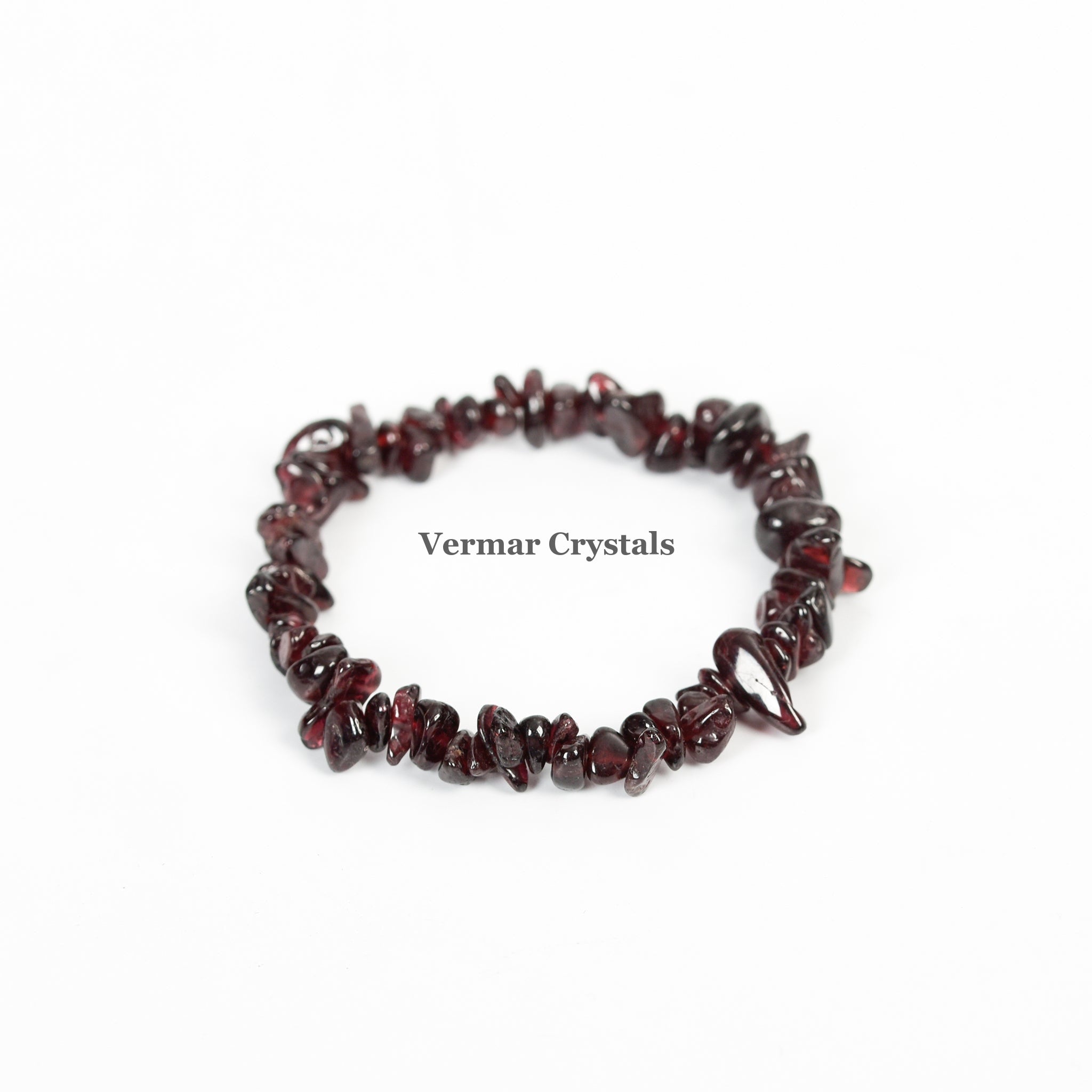 Handmade garnet chip bracelet with polished deep red irregular stones arranged in a circular shape on white background