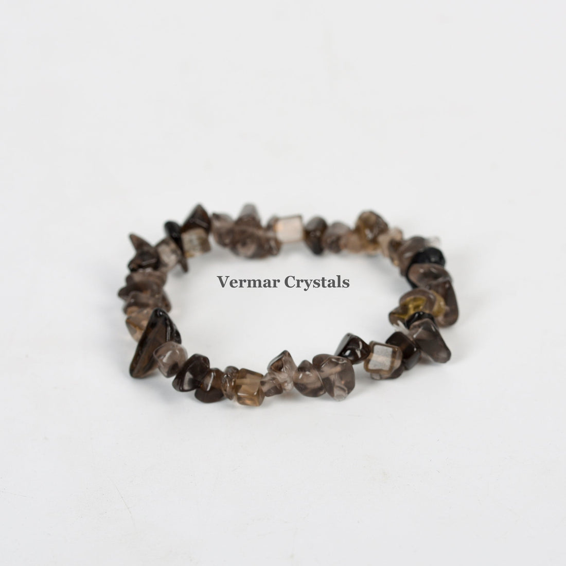 Handmade stretchy bracelet made of polished smoky quartz chip beads arranged in a circular shape on white background