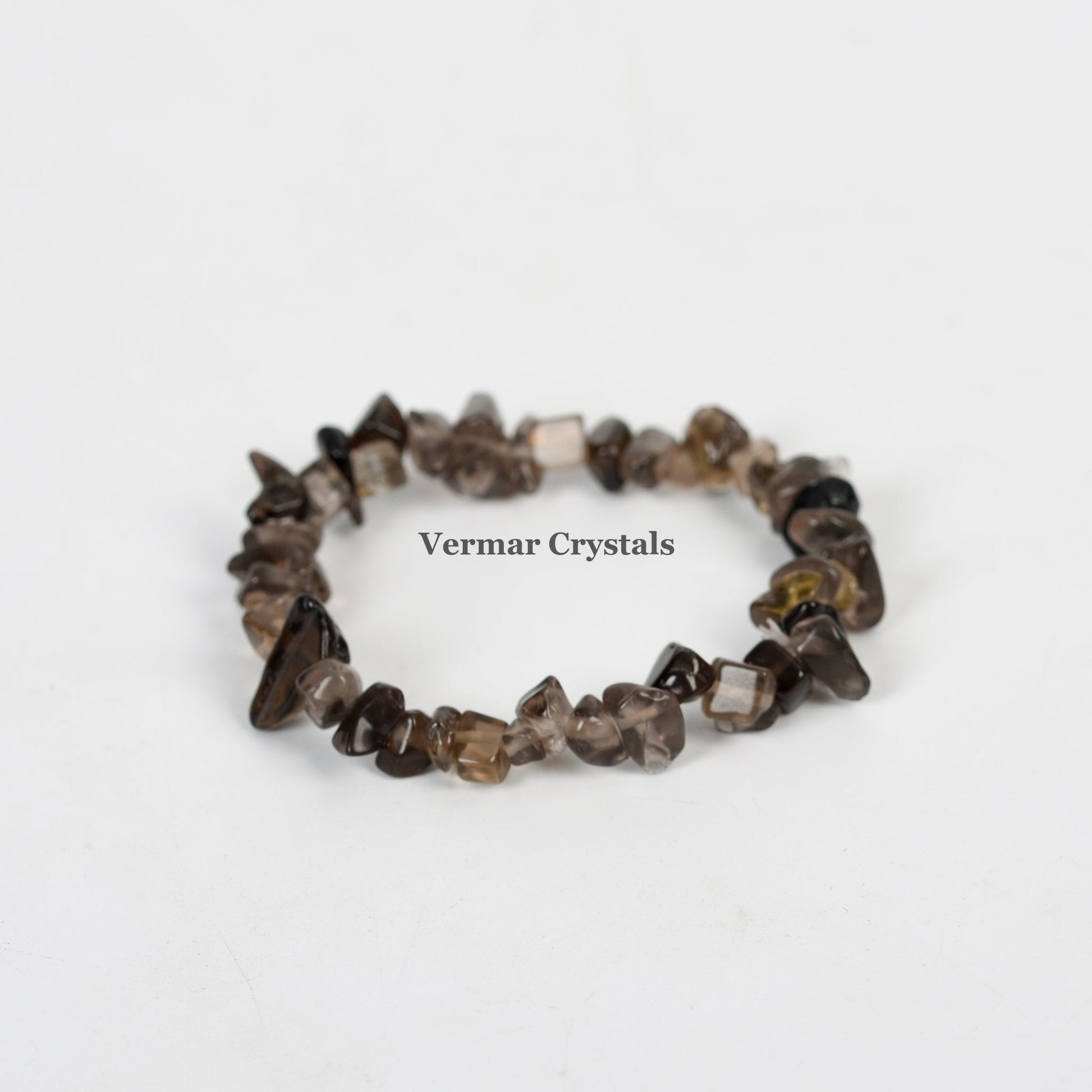 Handmade stretchy bracelet made of polished smoky quartz chip beads arranged in a circular shape on white background