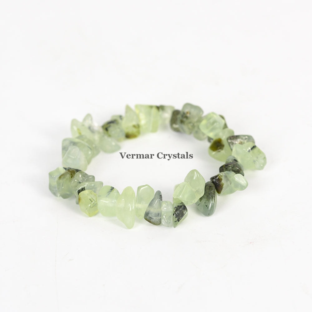 Handmade bracelet with irregular pale green Prehnite chip stones arranged in a circular shape on a white background