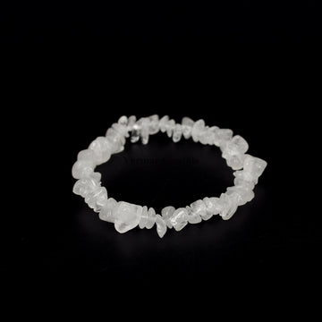 Handmade clear quartz chip bracelet with irregular polished translucent stones arranged in a circular shape on black background