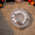White and garden phantom quartz bracelet with silver charms and a central magic box crystal on round stone plate