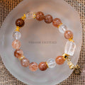 Close-up of Autumn Sunlight Bracelet with 10mm black rutilated quartz and clear quartz beads on frosted glass dish