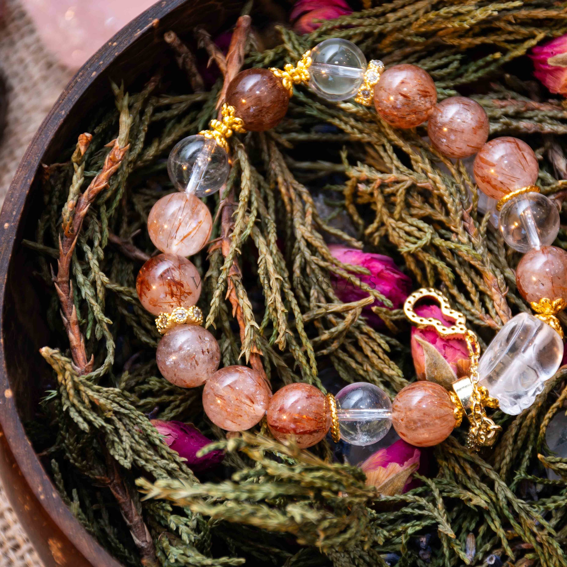Close-up of Autumn Sunlight bracelet with black rutilated quartz and clear quartz beads on dried foliage background