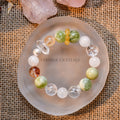 Fresh green and cream white Serpentine Jade bead bracelet with clear and amber stones on frosted round dish