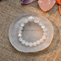 Blue Moonstone and freshwater pearl bracelet with zircon accents displayed on frosted glass dish on burlap background
