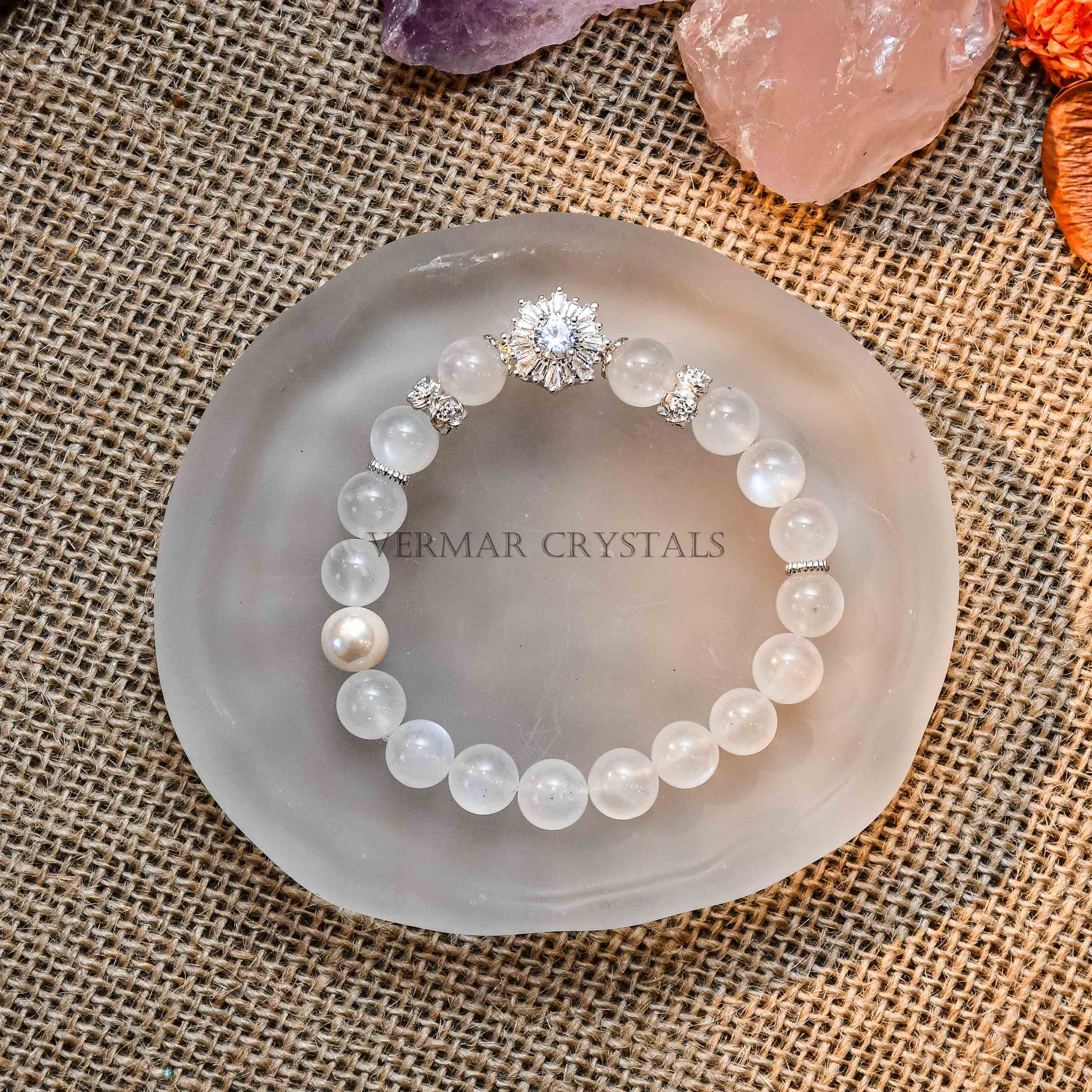 Blue Moonstone and freshwater pearl bracelet with zircon accents displayed on frosted glass dish on burlap background