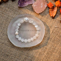 Blue Moonstone, pearl, and zircon bracelet displayed on a frosted glass dish with crystals and dried flowers nearby