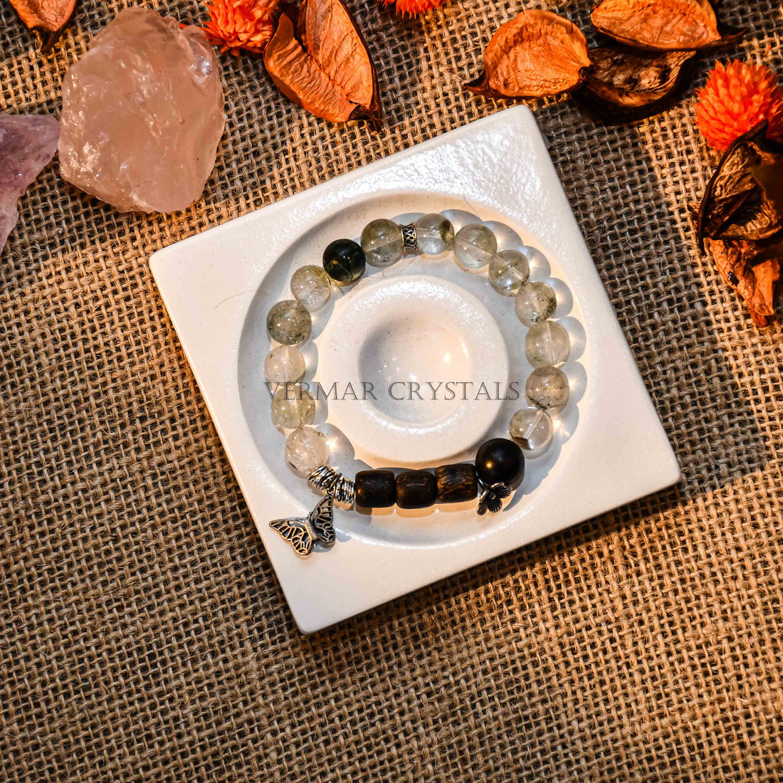 Beaded Forest Spirit & Agarwood Bracelet with translucent green stones, wooden beads, and butterfly charm on white background